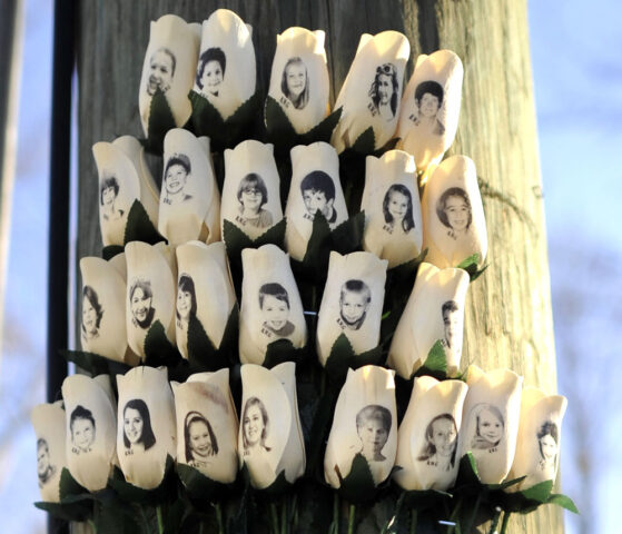 Roses with the faces of the Sandy Hook Elementary students and adults killed are seen on a pole in Newtown, Connecticut
