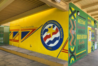 A photo from Baldwin Hills Elementary School, a painted wall showing the seal for "A California Distinguished School" in 2020 and painted words "Closing the achievement gap"