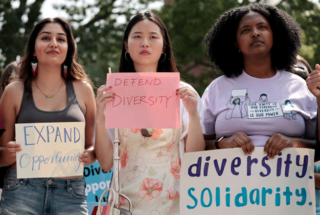 A photo of Harvard students rallying in protest to the Supreme Court’s ruling against affirmative action, holding signs that say "Expand opportunity," "Defend Diversity" and "Diversity Solidarity."