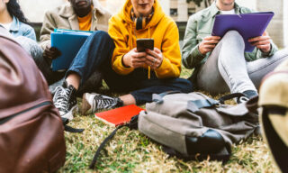 This is a photo of teenagers on their cell phones.